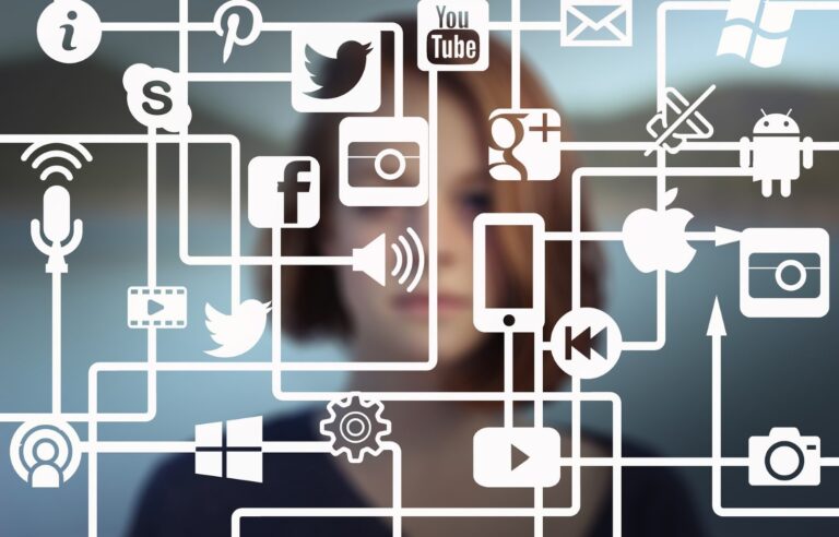 A blurred person in the background with interconnected social media and technology icons like Twitter, Facebook, YouTube, Android, Apple, and Windows overlayed in the foreground creates a captivating digital assets description. This scene is perfect for enhancing your SEO strategy.