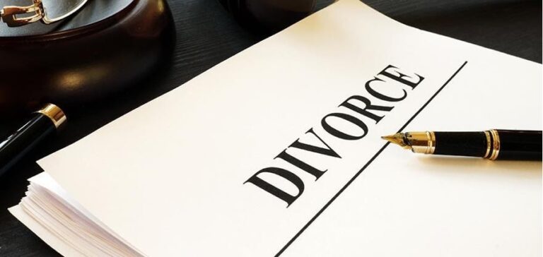 A stack of divorce papers with the word "DIVORCE" in bold lettering sits next to a black fountain pen, hinting at the complexities of estate planning Singapore often necessitates.